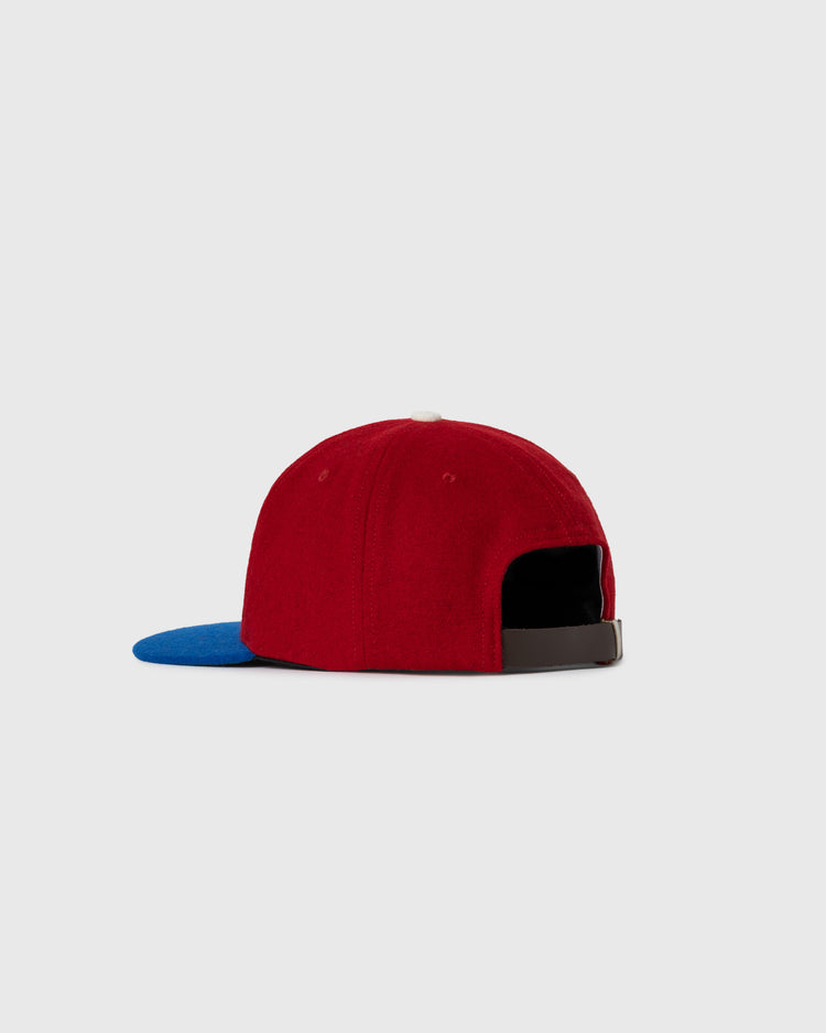 The EFF USA National Team 1956 Authentic Wool Ballcap is shown from the back, displaying its red crown, blue brim, and brown adjustable strap against a plain light gray background.