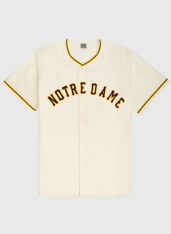The Ebbets Field University of Notre Dame 1956 Authentic Wool Home Baseball Jersey features vintage short sleeves, cream color, bold black and yellow NOTRE DAME lettering, and yellow trim—a true Fighting Irish classic.