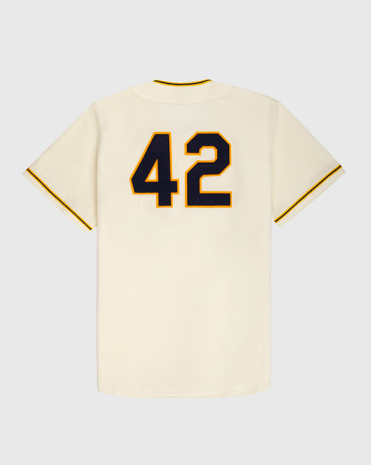 The University of Notre Dame 1956 Authentic Wool Home Baseball Jersey by Ebbets Field is cream-colored, featuring a large number 42 in black with yellow outline on the back, displayed against a plain light gray background.