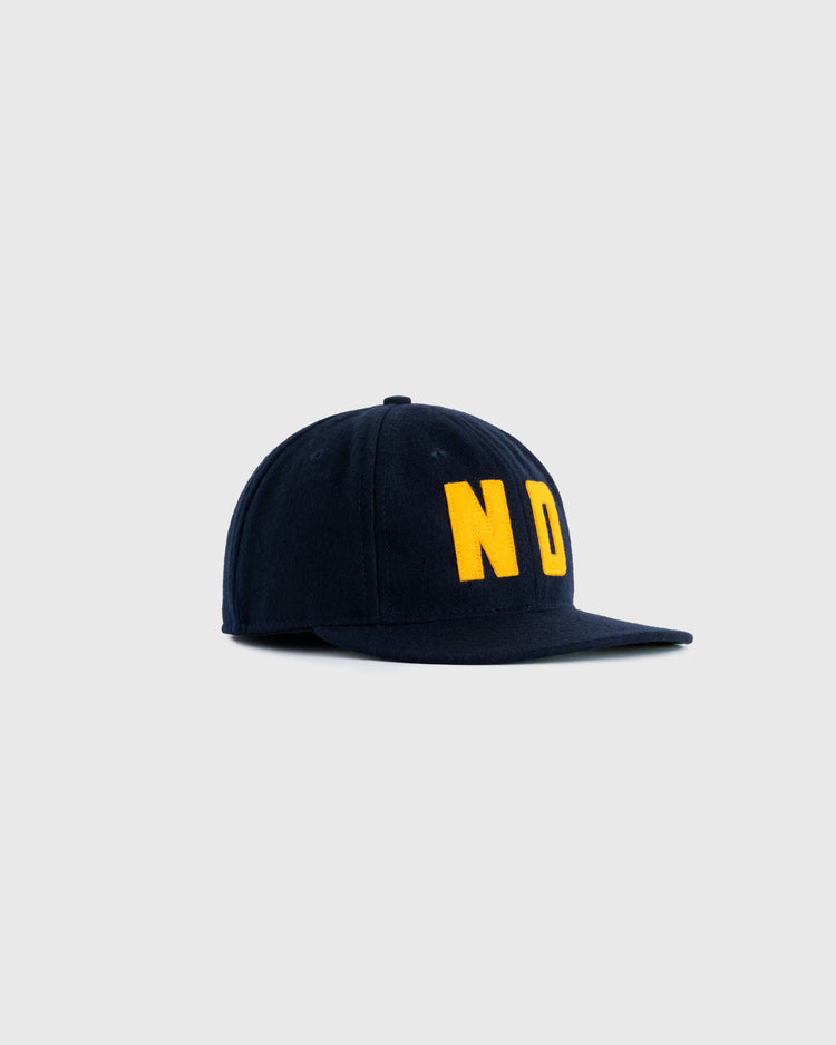 The EFF University of Notre Dame 1966 Authentic Wool Ballcap is navy blue, featuring bold yellow ND lettering on the front, displayed against a plain light gray background.