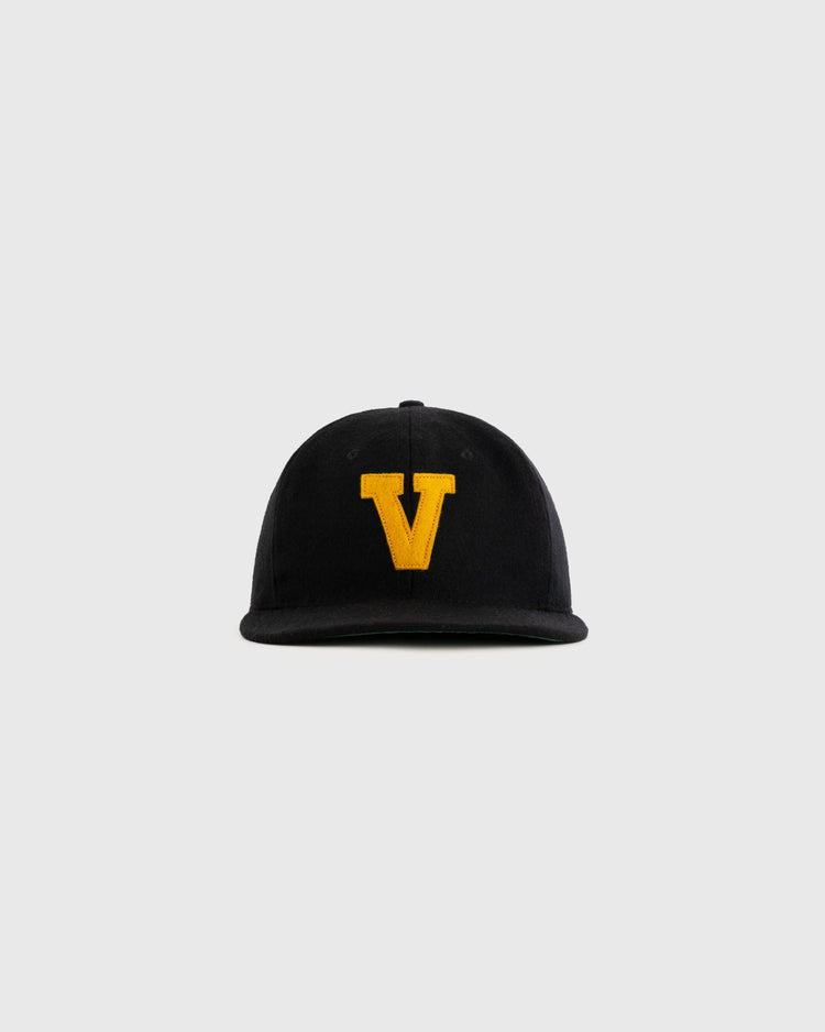 The EFF Vanderbilt University 1960 Authentic Wool Ballcap is a black vintage cap with a large yellow V embroidered on the front, displayed against a plain light gray background.