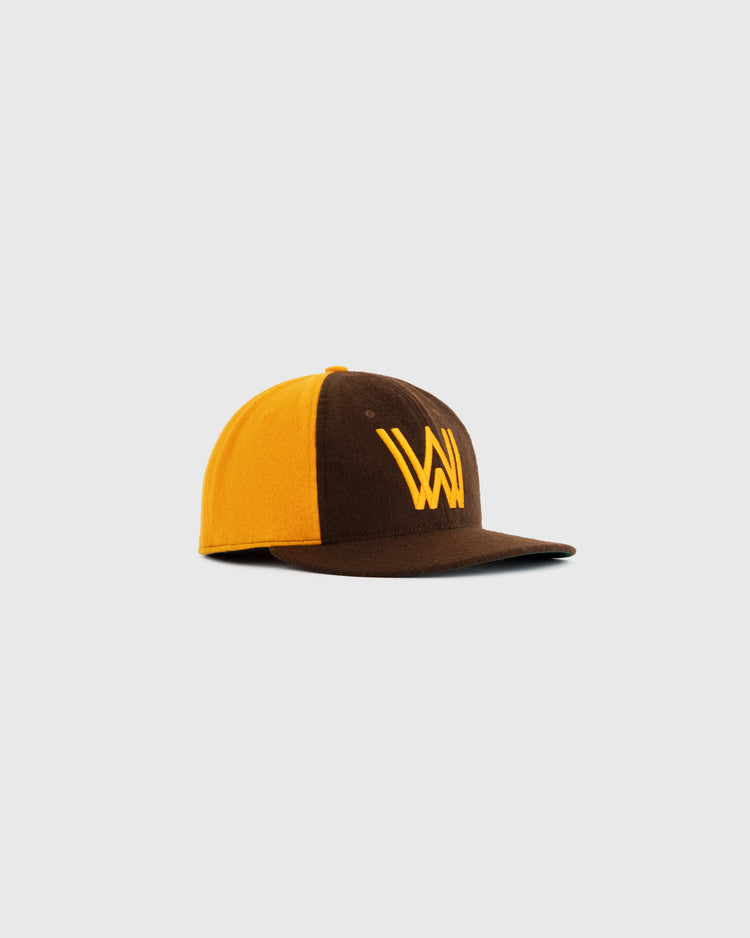 The EFF Walla Walla Padres 1974 Authentic Wool Ballcap is brown and yellow with a flat brim and features a stylized yellow W logo, inspired by the classic Northwest League design, shown on a plain white background.