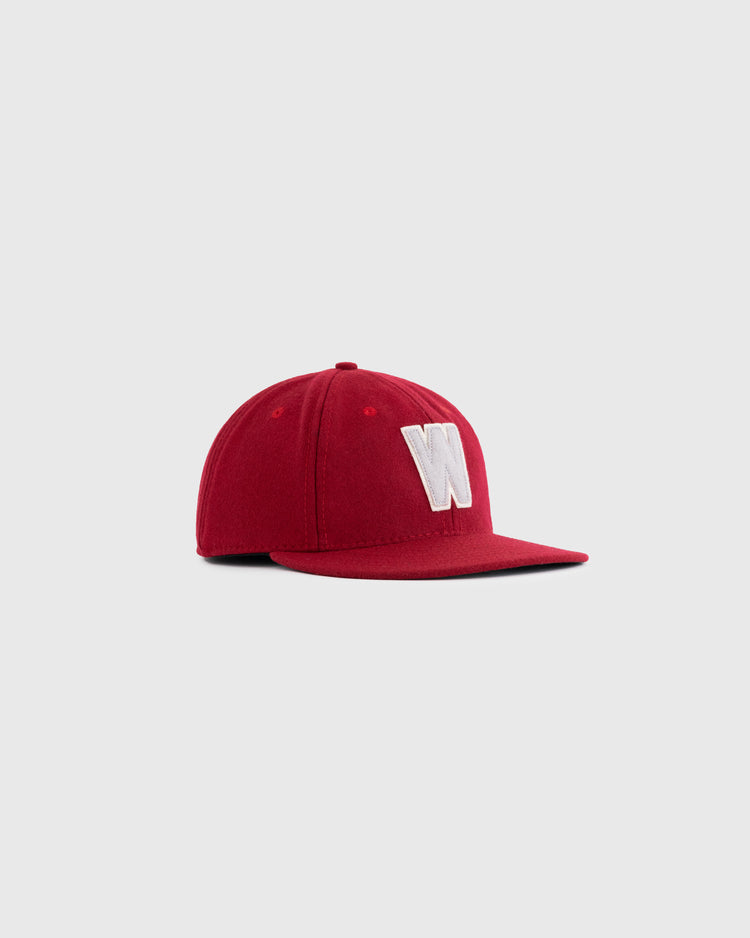 The EFF Washington State University 1956 Authentic Wool Ballcap, featuring a red flat brim and white “W” embroidery, is inspired by the original 1956 WSU design and shown on a plain light gray background.
