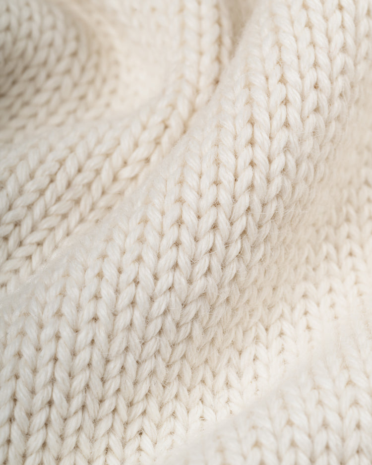 Close-up of the EFF Yale University 1923 Wool Shawl Collar Sweater, featuring cream-colored, thick, soft yarn and textured, wavy knit stitches reminiscent of vintage style.