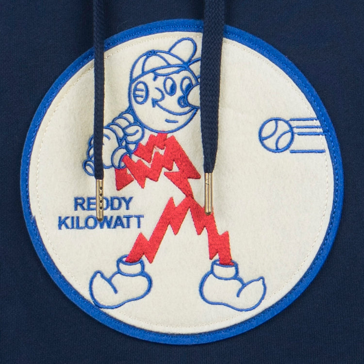 The EFF Reddy Kilowatt French Terry Script Hooded Sweatshirt in navy blue features the electric mascot Reddy Kilowatt—lightbulb head, red lightning bolt body—holding a baseball glove with “REDDY KILOWATT” in blue text.