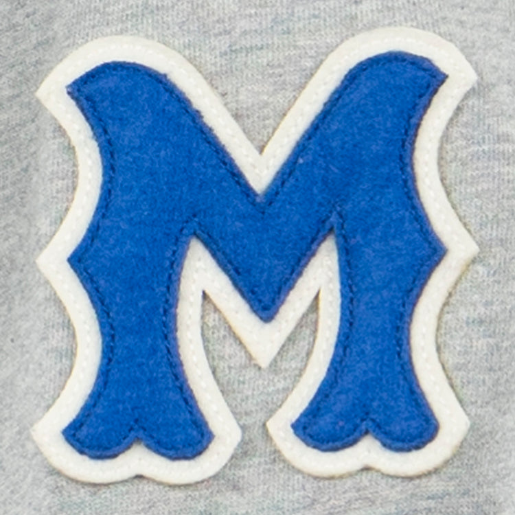 The EFF Montreal Royals French Terry Script Hooded Sweatshirt features a blue letter M with white trim and wavy edges, sewn onto light gray fabric—evoking classic Pittsburgh Pirates and Dodgers prospect styles.