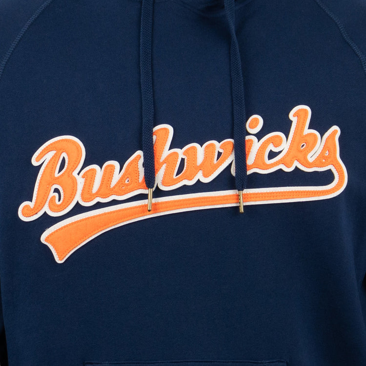 The EFF Brooklyn Bushwicks French Terry Script Hooded Sweatshirt features Bushwicks in orange and white script on navy blue, honoring New York’s legendary semi-pro baseball team.