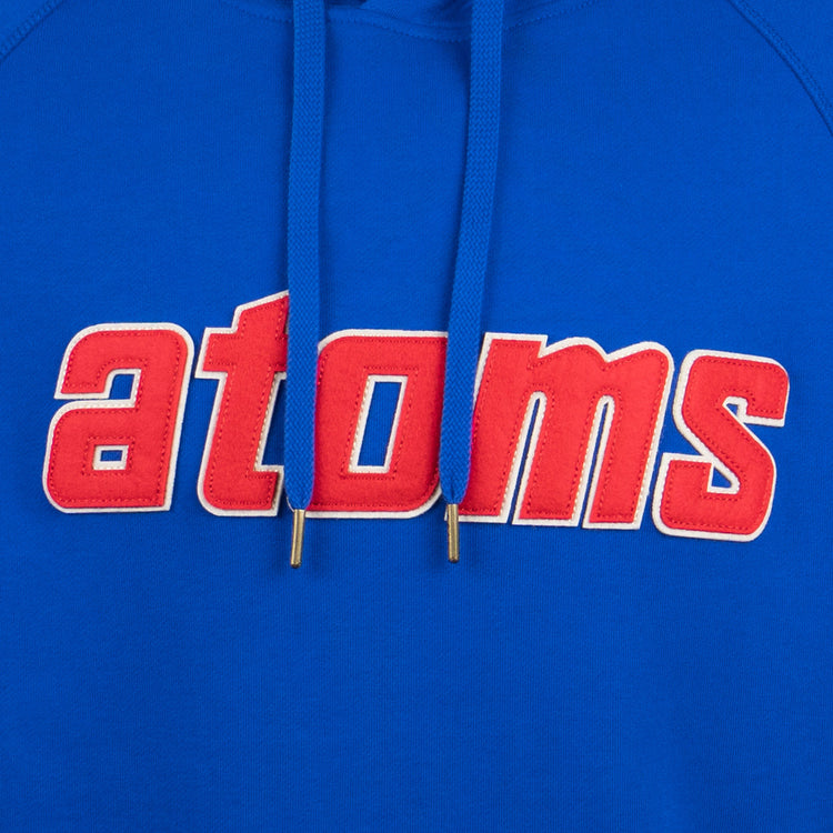 The EFF Sankei Atoms French Terry Script Hooded Sweatshirt features bold red and white “atoms” lettering across the chest, inspired by Atom Boy, with two blue drawstrings with metal tips.