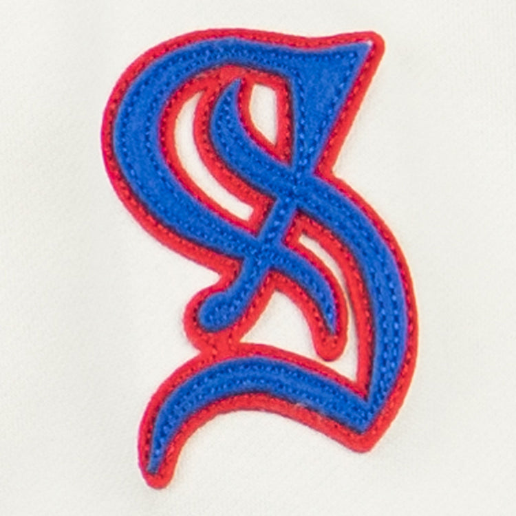 The EFF Santurce Cangrejeros French Terry Script Hooded Sweatshirt in Natural features a blue and red stylized S patch with intricate curves, inspired by the Puerto Rican League’s dynamic spirit.