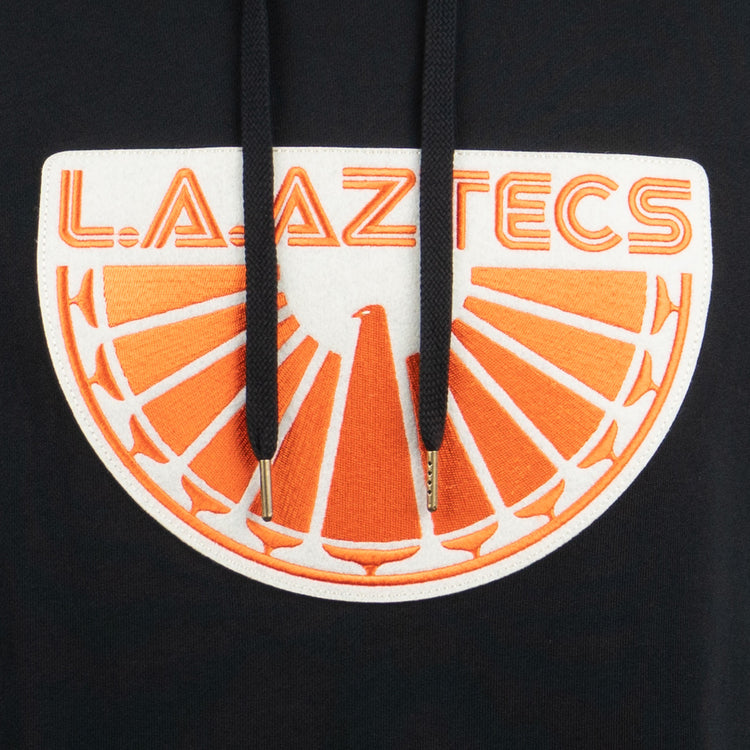 Celebrate the iconic NASL team with the EFF Los Angeles Aztecs French Terry Script Hooded Sweatshirt, featuring L.A. AZTECS in orange above a bold orange and white half-sun and bird design on black.