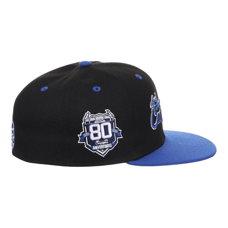 The EFF Santurce Cangrejeros NLB Flip Fitted Ballcap in black features a blue brim, 80th Anniversary patch, Santurce logo, and vibrant designs honoring the Puerto Rican League.