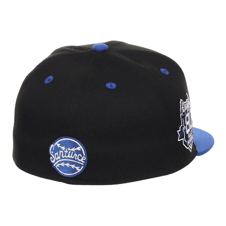 The EFF Santurce Cangrejeros NLB Flip Fitted Ballcap in black features blue and white embroidered patches, including a Sanitune name patch. Viewed from the back, it has a blue top button and brim—ideal for classic style fans.