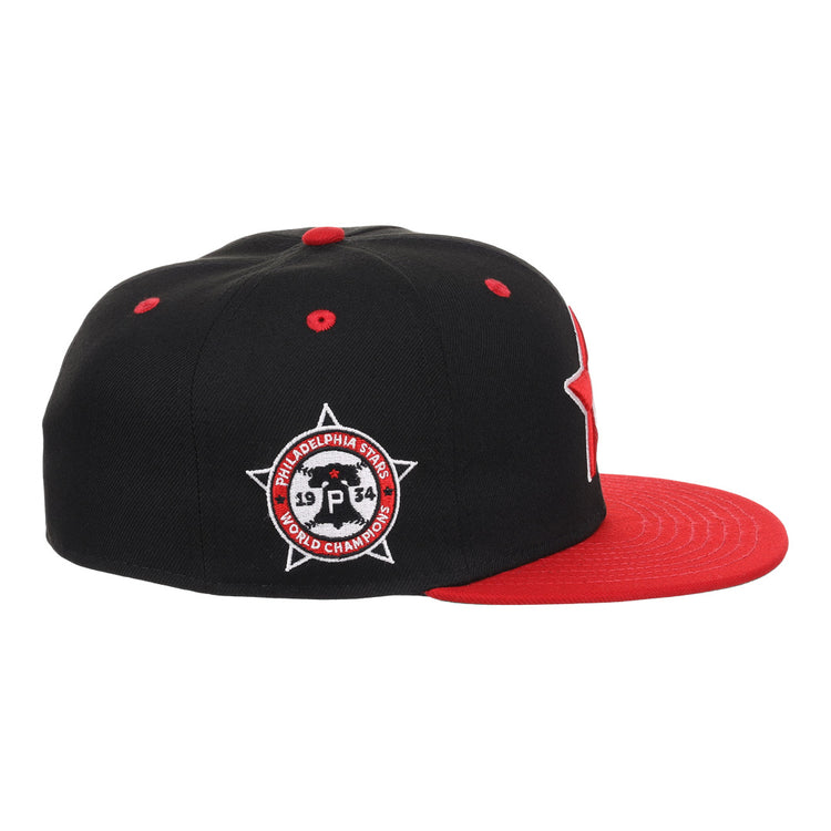 The EFF Philadelphia Stars NLB Flip Fitted Ballcap features a black and red design, flat red brim, and side patch reading Philadelphia Stars 1934 World Champions, honoring the Negro National League with a star and circle motif.