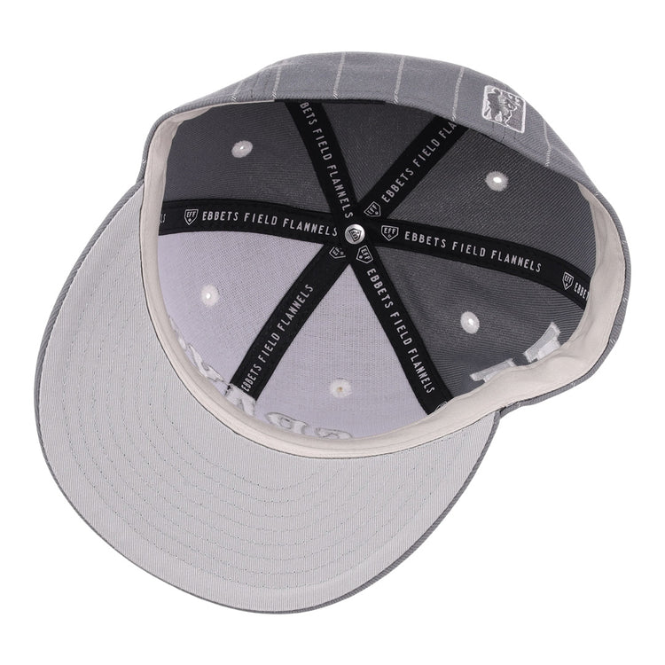 A top view of the EFF Homestead Grays NLB Black Pinstripe Fitted Ballcap, showing black and white “EBBETS FIELD FLANNELS” seams, white ventilation holes, and a light grey underside on this vintage Negro National League cap.