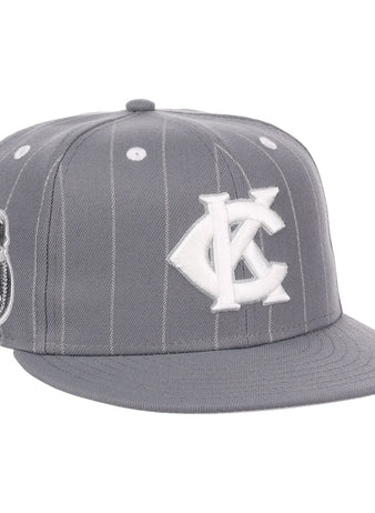 The EFF Kansas City Monarchs NLB Black Pinstripe Fitted Ballcap features white pinstripes, a white KC logo, a Negro National League-inspired side patch, flat brim, button top, and classic Monarchs baseball style accents.