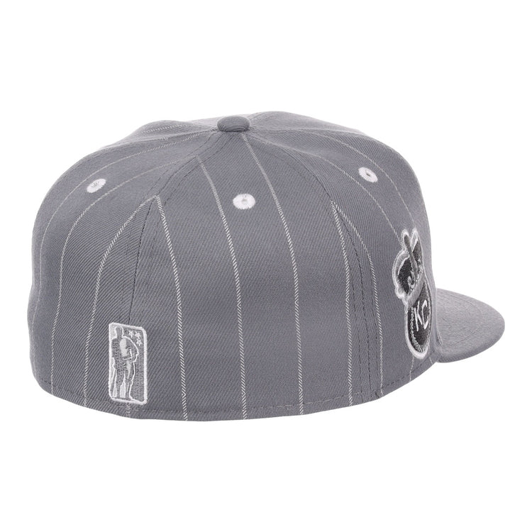 The EFF Kansas City Monarchs NLB Black Pinstripe Fitted Ballcap is shown from the back left, highlighting a small Monarchs player logo and a large circular KC logo on the side—celebrating Negro National League heritage.