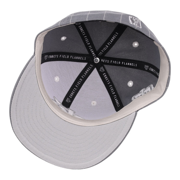 Top-down view of a Kansas City Monarchs NLB Black Pinstripe Fitted Ballcap by EFF, showing white stitched eyelets, black lining with “EBBETS FIELD FLANNELS” text, and a light gray underbill—honoring Negro National League heritage.