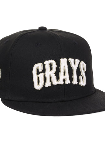 The EFF Homestead Grays Josh Gibson Fitted Ballcap in black features bold white GRAYS lettering on the front and a small embroidered portrait patch with text on the left side.