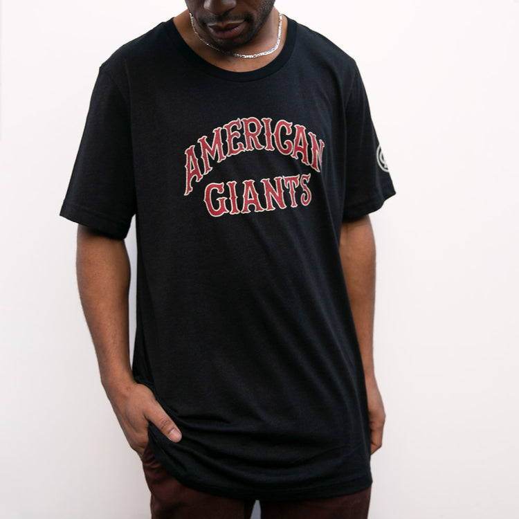 A person wears the EFF Chicago American Giants T-Shirt, featuring “CHICAGO AMERICAN GIANTS” in red and white letters, honoring Black baseball heritage, while standing against a plain white background.