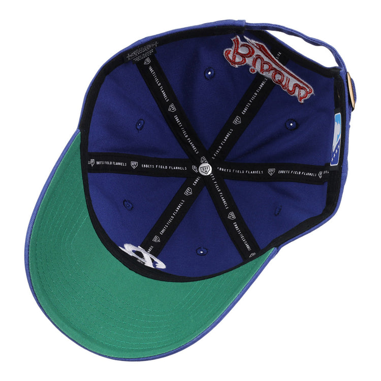 The Ebbets Field Buffalo Bisons MiLB Dad Ballcap is blue with a green underbrim, blue eyelets, black inner seams featuring white text, and a red embroidered logo on the inner band.