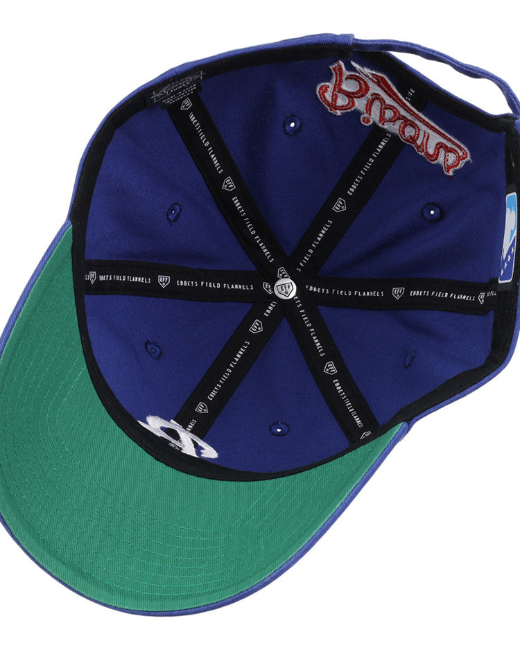 The Ebbets Field Buffalo Bisons MiLB Dad Ballcap is blue with a green underbrim, blue eyelets, black inner seams featuring white text, and a red embroidered logo on the inner band.