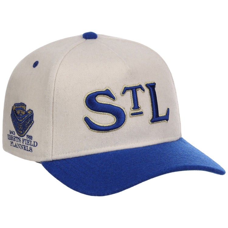 The St. Louis Stars NLB Ballpark A-Frame Ballcap by Ebbets Field features a cream and blue design, STL in blue and gold on the front, a blue bill, and a side patch with Ebbets Field Flannels, stadium logo, and 1988.