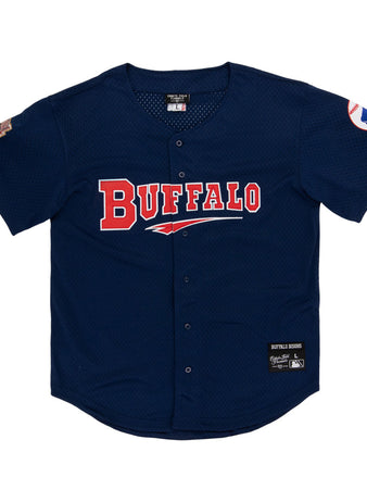 The Ebbets Field Buffalo Bisons MiLB Button Down Jersey features navy blue fabric, BUFFALO in red and white on the front, team patches on both sleeves, and a center button closure.