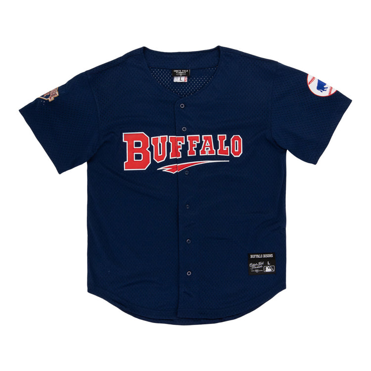 The Ebbets Field Buffalo Bisons MiLB Button Down Jersey features navy blue fabric, BUFFALO in red and white on the front, team patches on both sleeves, and a center button closure.