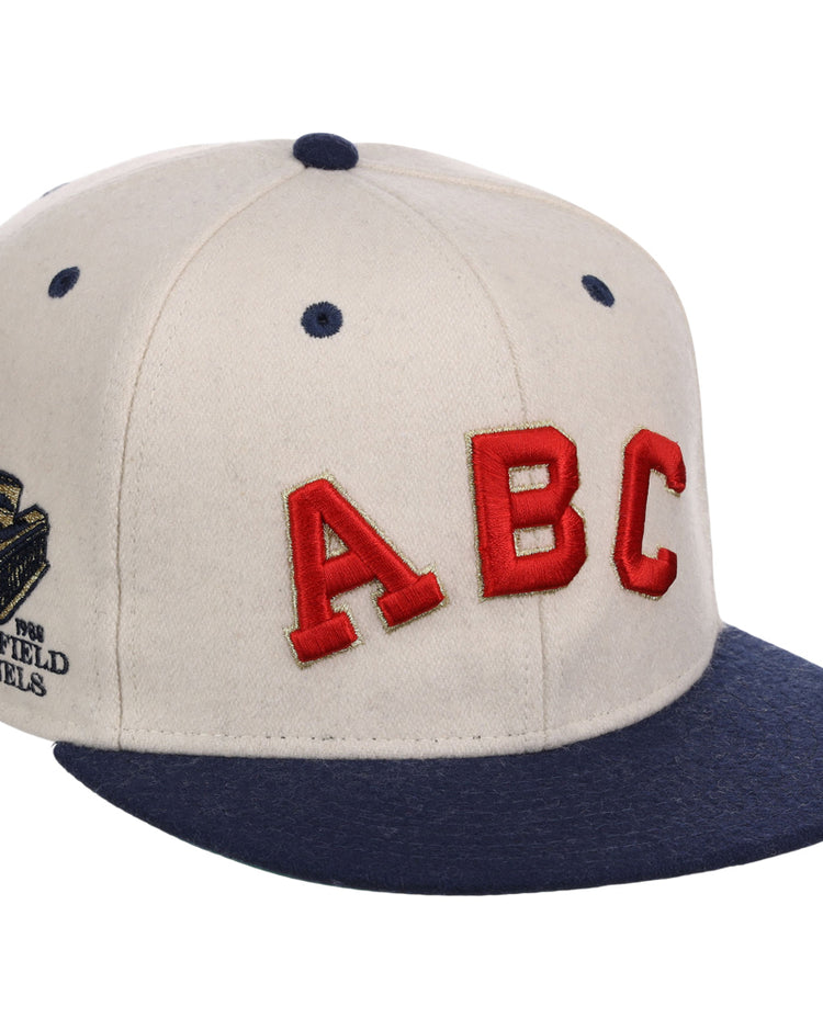 The Atlanta Black Crackers NLB Ballpark Fitted Ballcap by Ebbets Field features a cream crown, navy brim and button, bold red ABC letters on the front, and a gold 