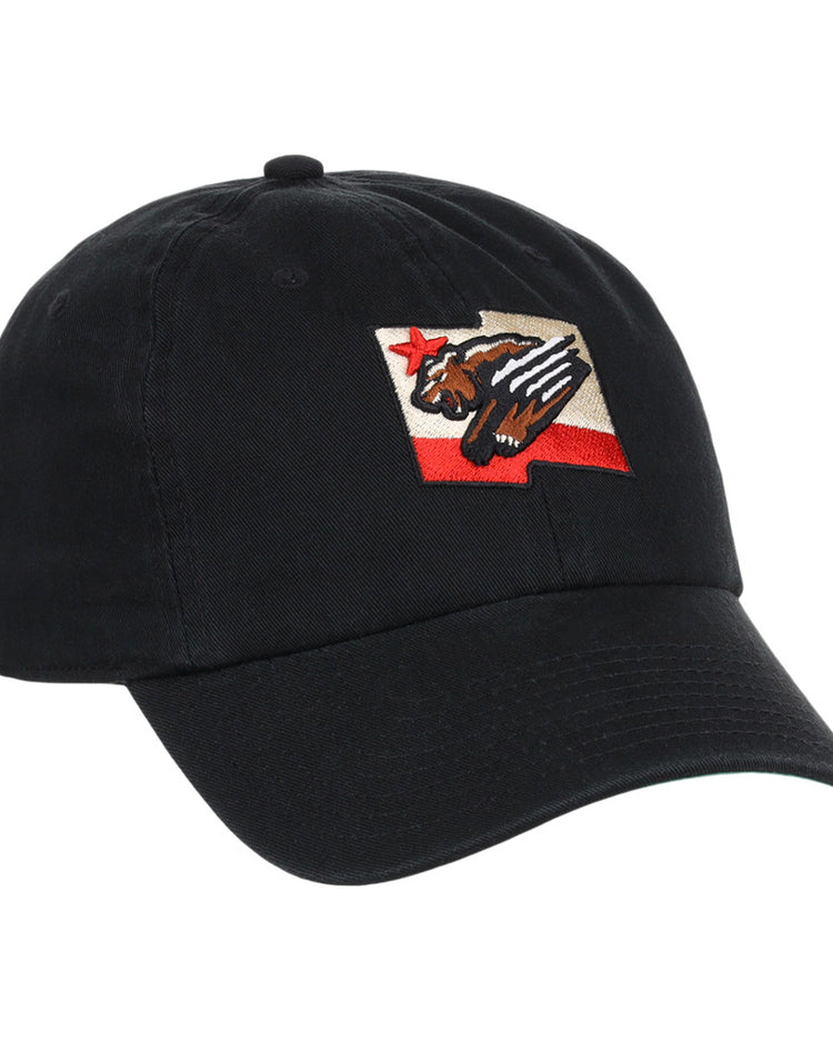 The Fresno Grizzlies MiLB Dad Ballcap by Ebbets Field is a black cap featuring a patch with a stylized bear, red star, and red stripe, inspired by the California state flag design.