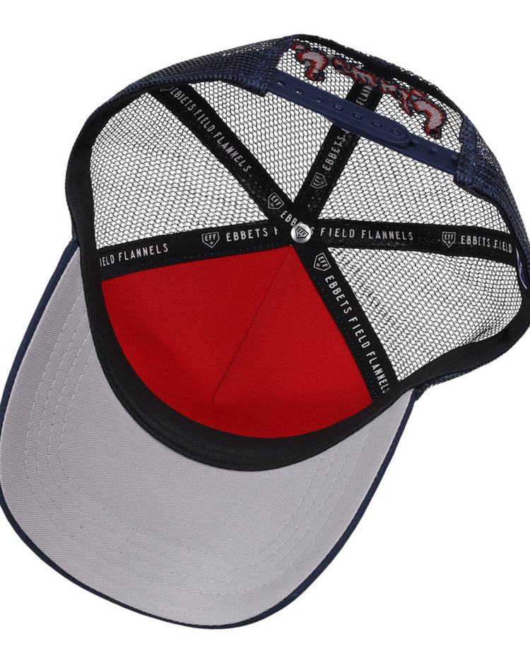Inside view of the Nashville Sounds MiLB Square Patch Trucker Ballcap by Ebbets Field, featuring a navy brim, red front panel, black inner band with EBBETS FIELD FLANNELS text, and black mesh sides and back.
