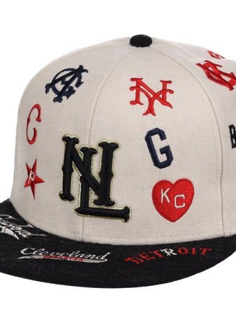 The Ebbets Field Negro League Baseball NLB Ballpark Fitted Ballcap features a beige crown, black brim, and colorful embroidered team logos and initials like NL, NY, KC in a heart, plus city names such as Cleveland and Detroit on the brim.