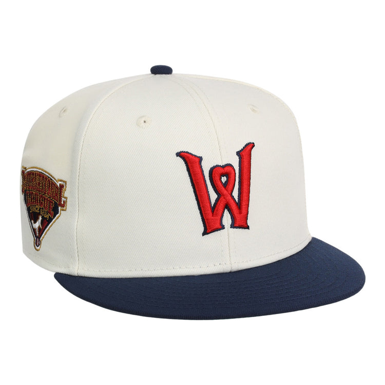 The Ebbets Field Worcester Red Sox MiLB Snapback Ballcap is a white cap with a navy blue brim, red W logo on the front, and a commemorative patch on the left side.