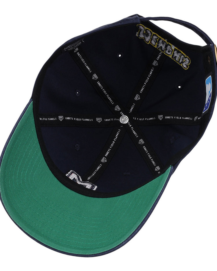 A look inside the Memphis Redbirds MiLB Dad Ballcap by Ebbets Field shows a navy interior with a green underbrim, black bands with white logos, visible sweatband and seam taping, plus an adjustable strap at the back.