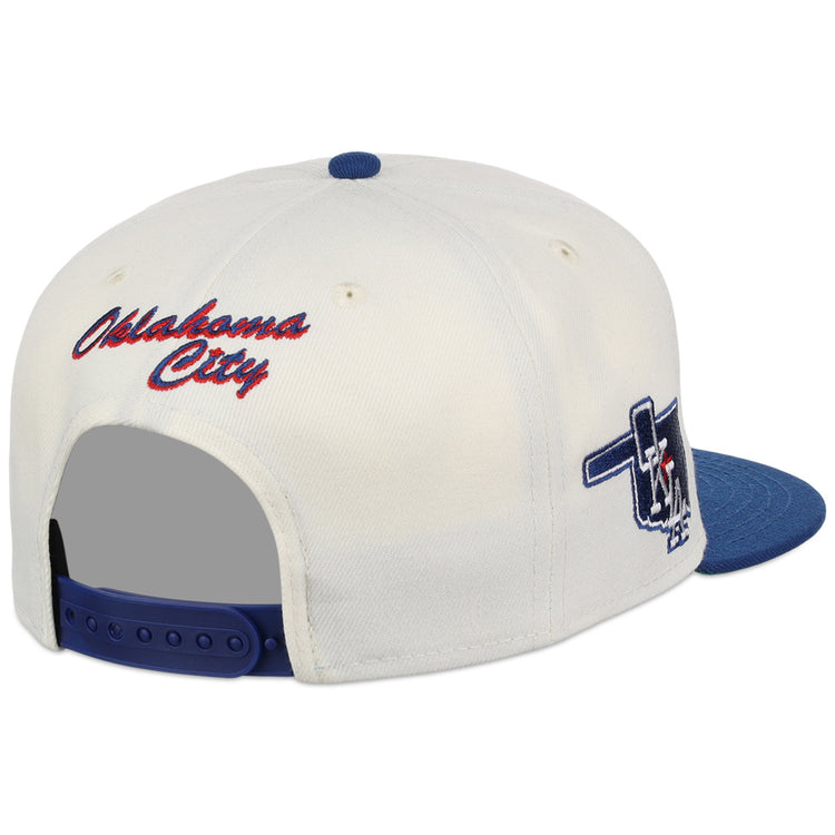 The Ebbets Field Oklahoma City Dodgers MiLB Snapback Ballcap features a white and blue design, red 