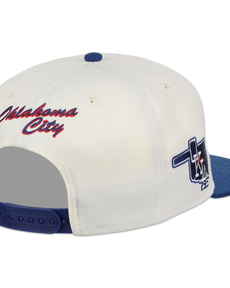 The Ebbets Field Oklahoma City Dodgers MiLB Snapback Ballcap features a white and blue design, red 