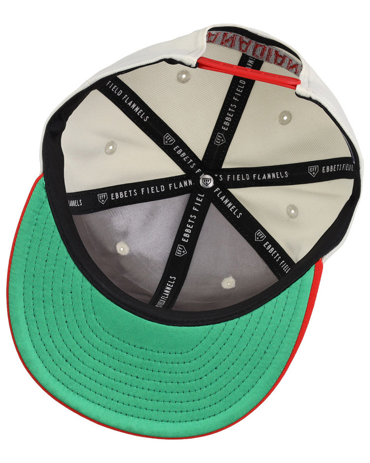 The underside of the Vancouver Canadians MiLB Snapback Ballcap by Ebbets Field features a green brim, red trim, cream interior, and black taping labeled 