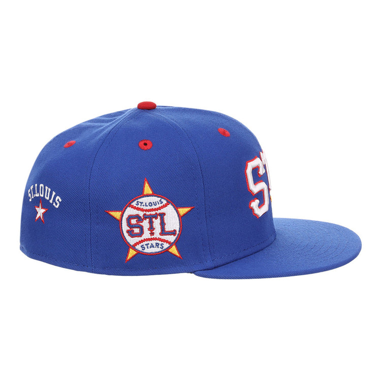 The Ebbets Field St. Louis Stars NLB Varsity Fitted Ballcap is a blue cap with red and white accents, large white and red STL letters on the front, ST. LOUIS text, and an STL-in-yellow-star patch on the side.