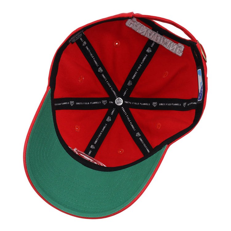 The underside of the Vancouver Canadians MiLB Dad Ballcap by Ebbets Field features a green brim, black inner taping with white text, and a side size sticker. The cap is shown upside down to display its interior details.