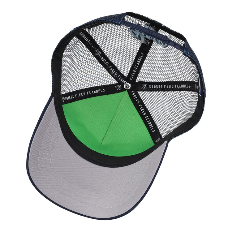 The Hillsboro Hops MiLB Trucker Ballcap by Ebbets Field features a blue mesh, gray brim, green inner front panel, and black mesh underside with branded “EBBETS FIELD FLANNELS” taping.