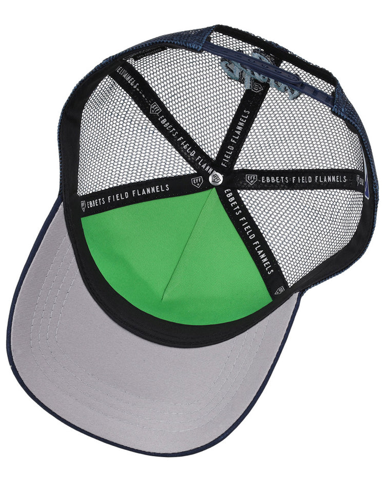 The Hillsboro Hops MiLB Trucker Ballcap by Ebbets Field features a blue mesh, gray brim, green inner front panel, and black mesh underside with branded “EBBETS FIELD FLANNELS” taping.