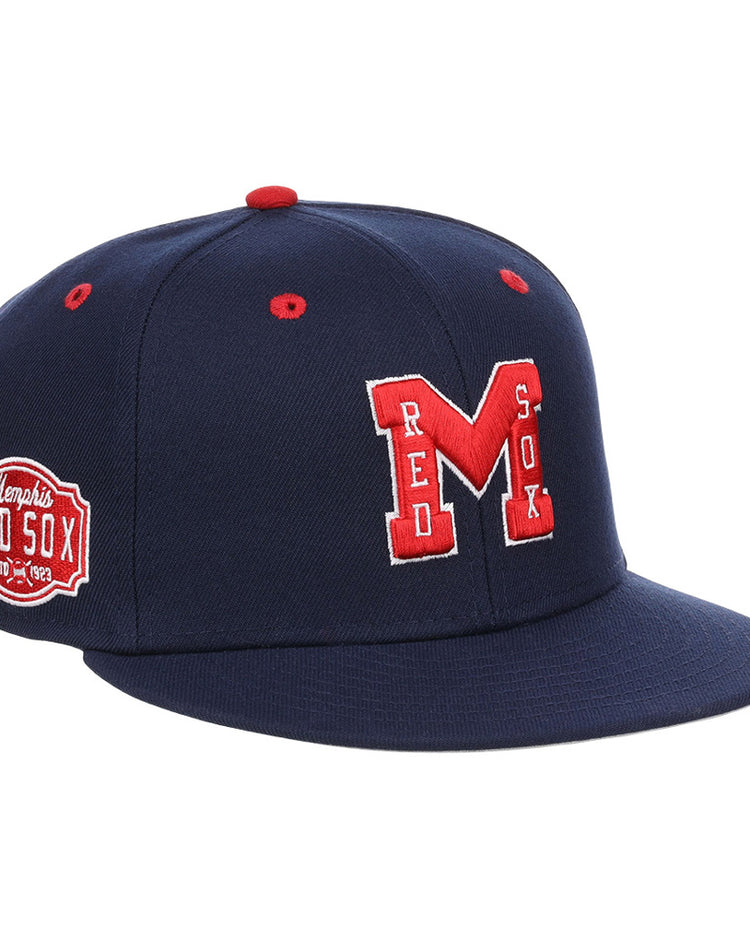 The Ebbets Field Memphis Red Sox NLB Varsity Fitted Ballcap features a navy base, red “M” and RED SOX embroidery on the front, red top accents, and a Memphis Red Sox patch on the side.