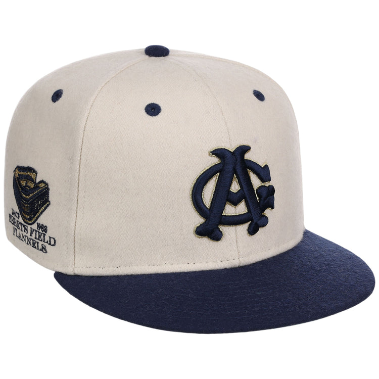 The Ebbets Field Chicago American Giants NLB Ballpark Fitted Ballcap features a beige crown, navy blue brim and button, navy embroidered front logo, and a commemorative side patch.