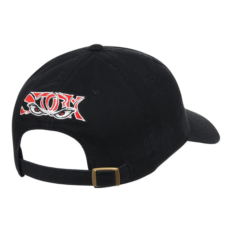 The Ebbets Field Lake Elsinore Storm MiLB Dad Ballcap is a black cap featuring red and white embroidered eyes on the back, plus an adjustable strap with a brass buckle.