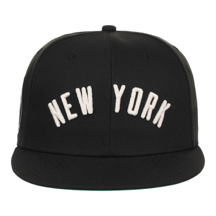 The Ebbets Field New York Black Yankees NLB Black/White Fitted Ballcap features large white 