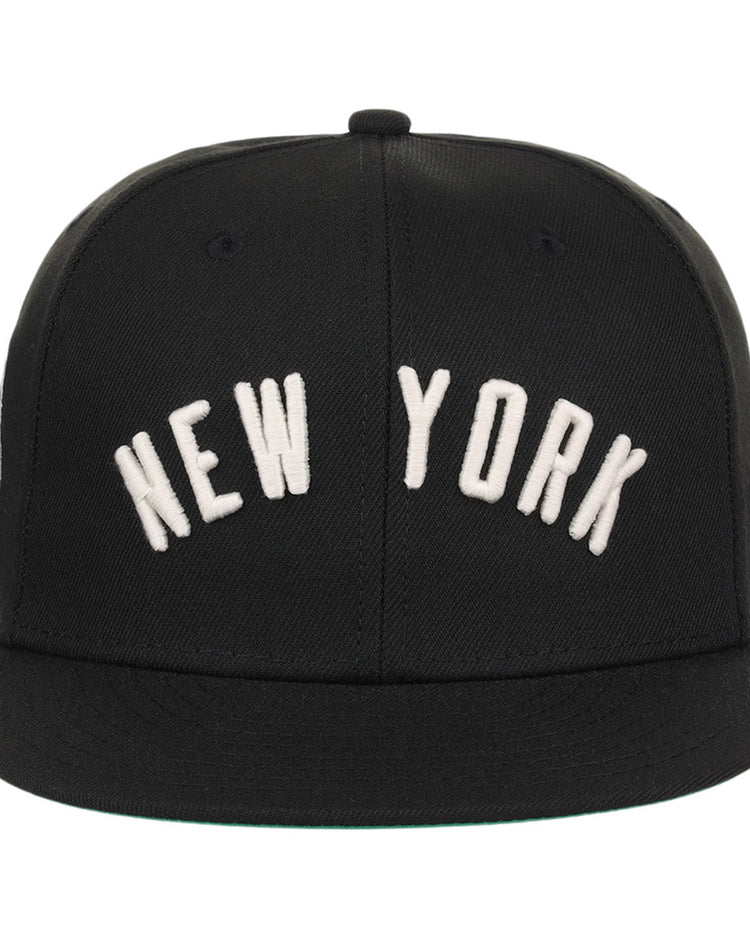 The Ebbets Field New York Black Yankees NLB Black/White Fitted Ballcap features large white 