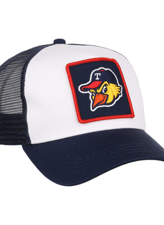 The Toledo Mud Hens MiLB Trucker Ballcap by Ebbets Field features a white front, navy bill, black mesh back, and a patch of a cartoon bird in a cap with the letter T on the front.