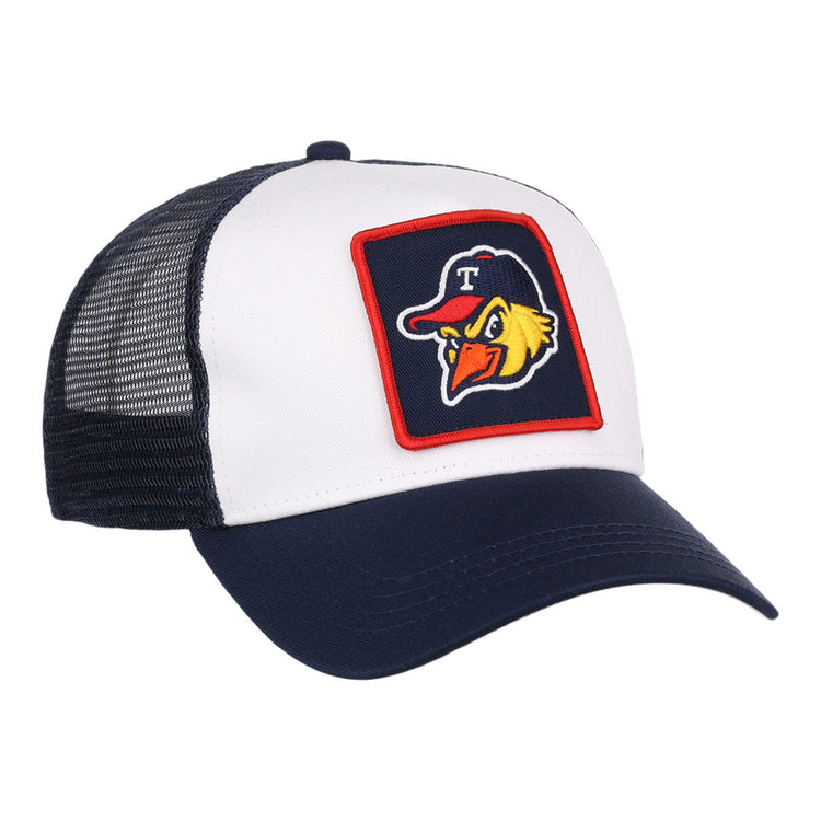 The Toledo Mud Hens MiLB Trucker Ballcap by Ebbets Field features a white front, navy bill, black mesh back, and a patch of a cartoon bird in a cap with the letter T on the front.