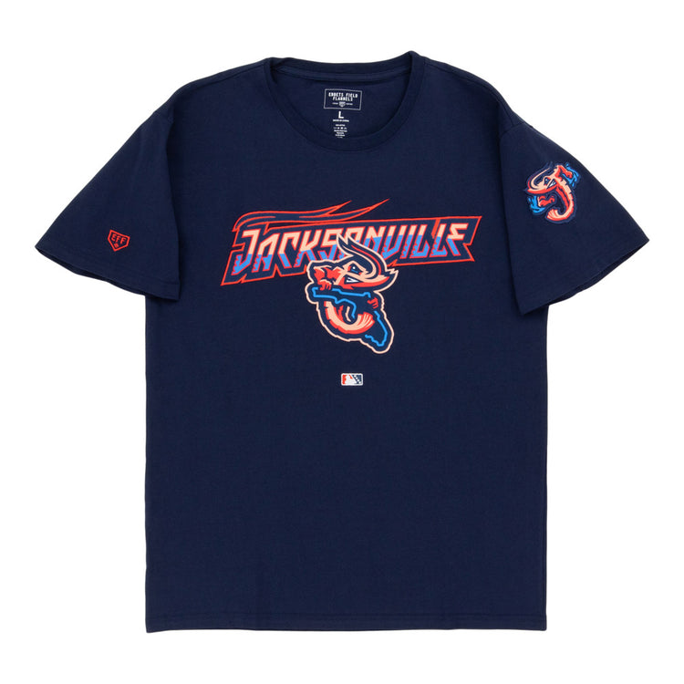 The Ebbets Field Jacksonville Jumbo Shrimp MiLB Fashion Cotton Short Sleeve Tee is navy blue with team logo and text on the chest, a shrimp logo on the left sleeve, and a small MLB logo near the hem.