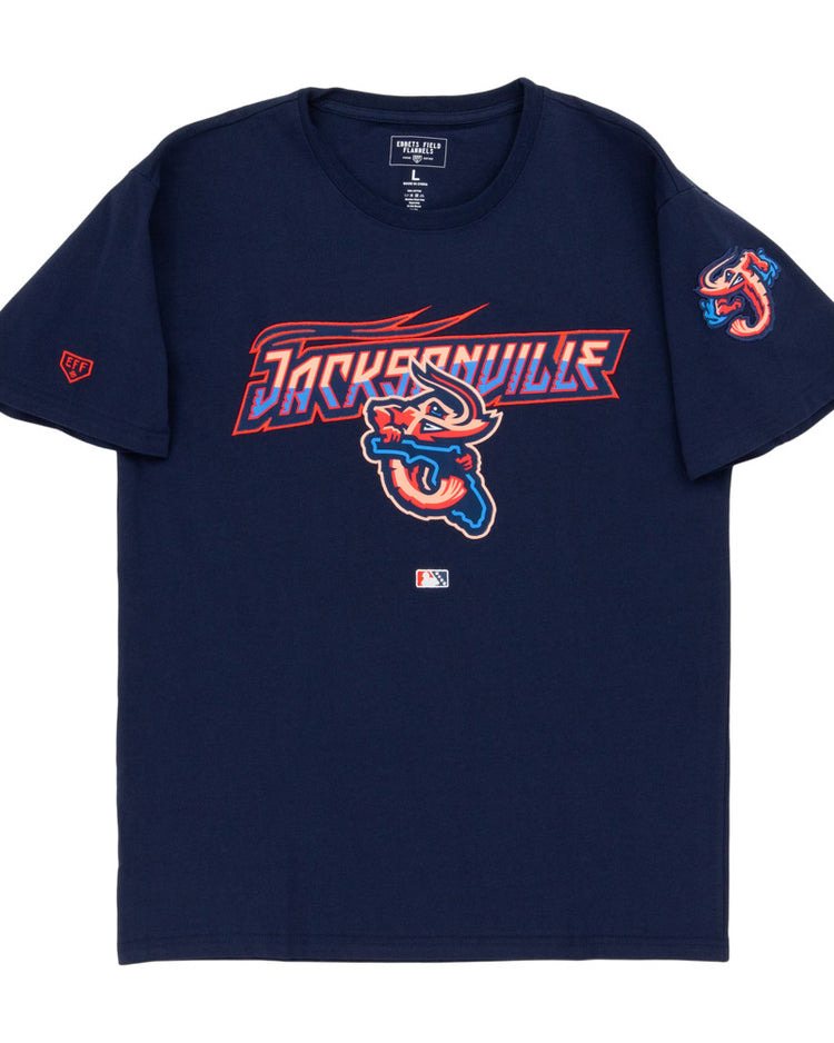 The Ebbets Field Jacksonville Jumbo Shrimp MiLB Fashion Cotton Short Sleeve Tee is navy blue with team logo and text on the chest, a shrimp logo on the left sleeve, and a small MLB logo near the hem.